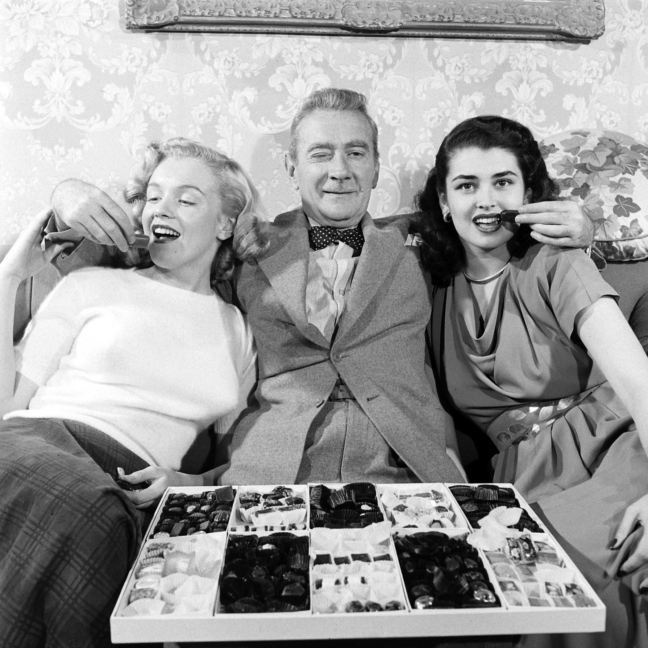 Then-unknown actress Marilyn Monroe with Clifton Webb and Laurette Luez on the set of a 1948 comedy, "Sitting Pretty."