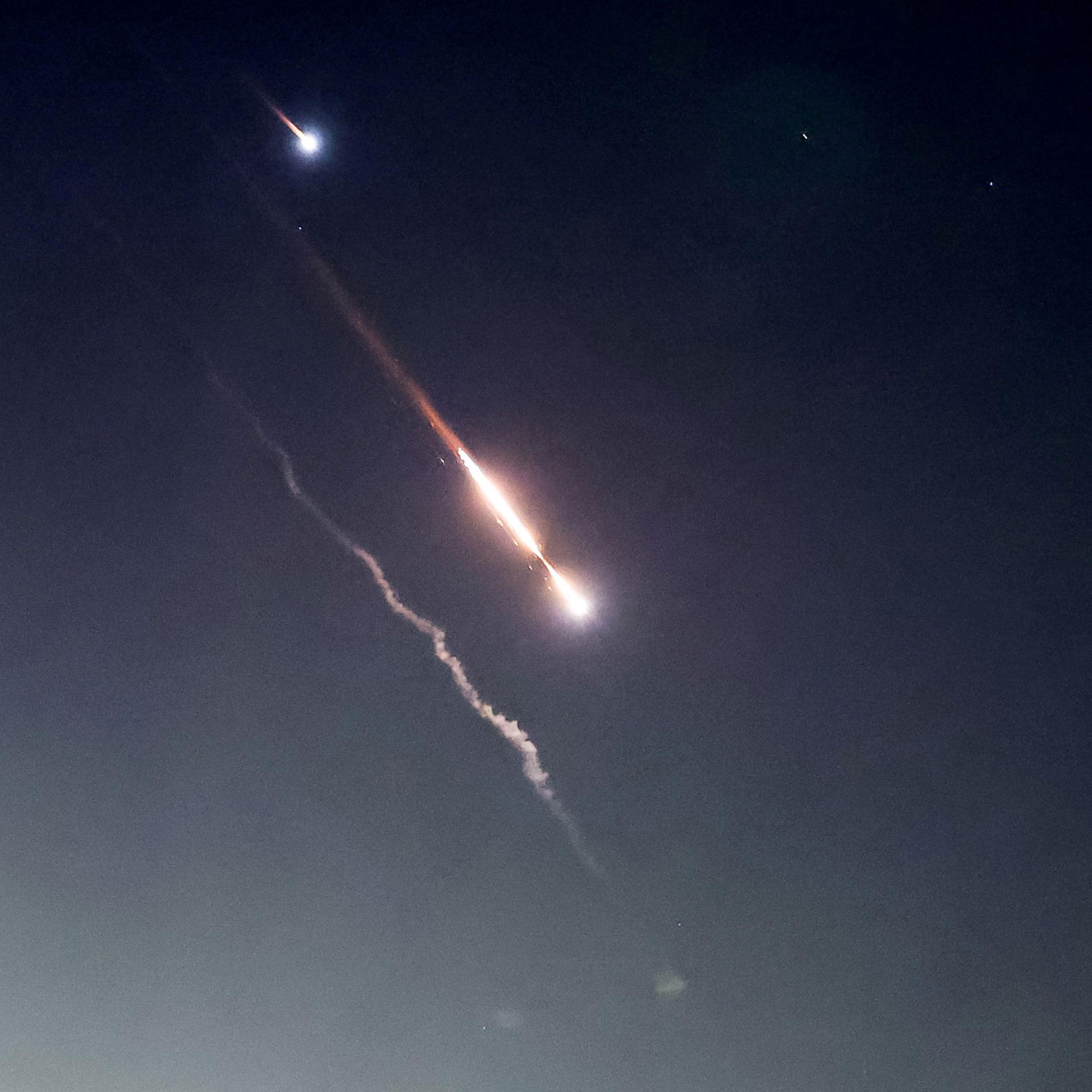 Objects are seen in the sky above Jerusalem after Iran launched drones and missiles towards Israel