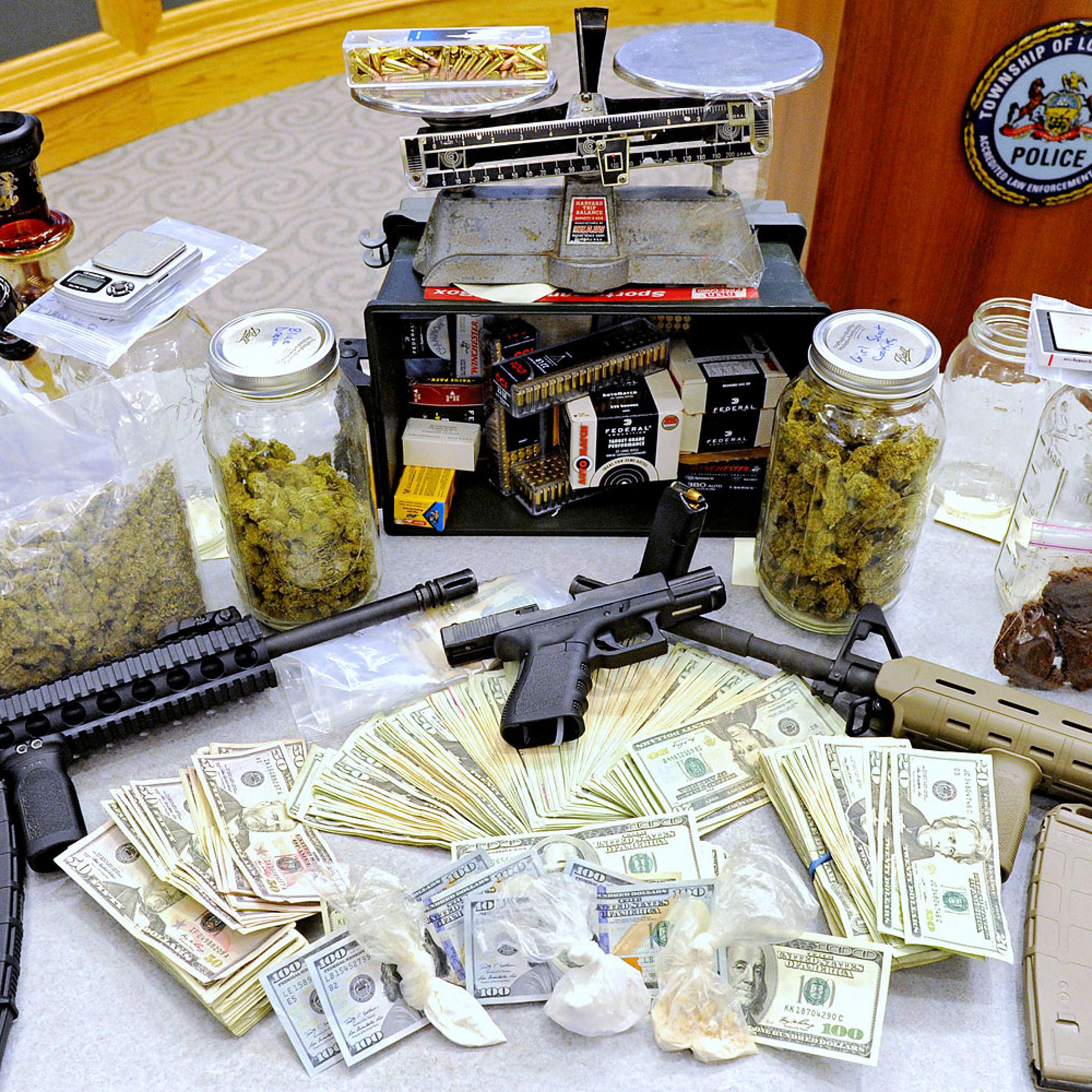 This photo shows drugs, money, guns and other illegal items that were seized when Lower Merion Police broke up a drug distribution ring during a new conference in Montgomery County, Pa, Monday, April 21, 2014.