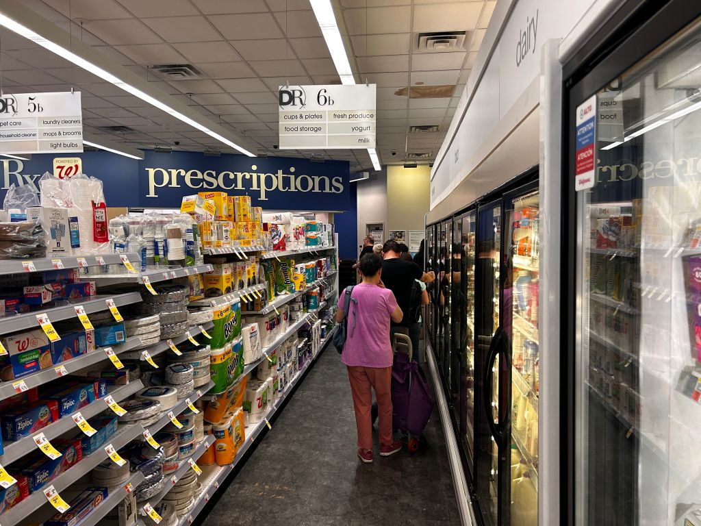 Long line of customers waiting to pick up Prescriptions at Walgreens pharmacy, Queens, New York