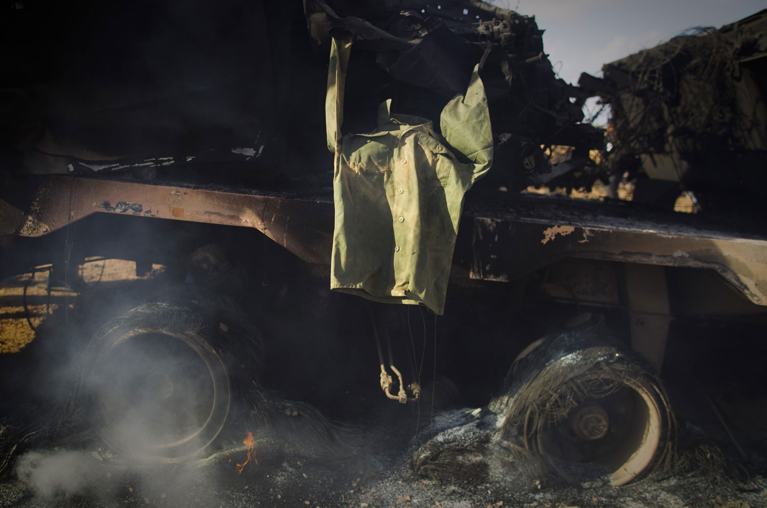 A soldier's jacket belonging to forces of Muammar Gaddafi is displayed on a burning tank on the outskirts of Benghazi, Libya, on <br>March 20, 2011