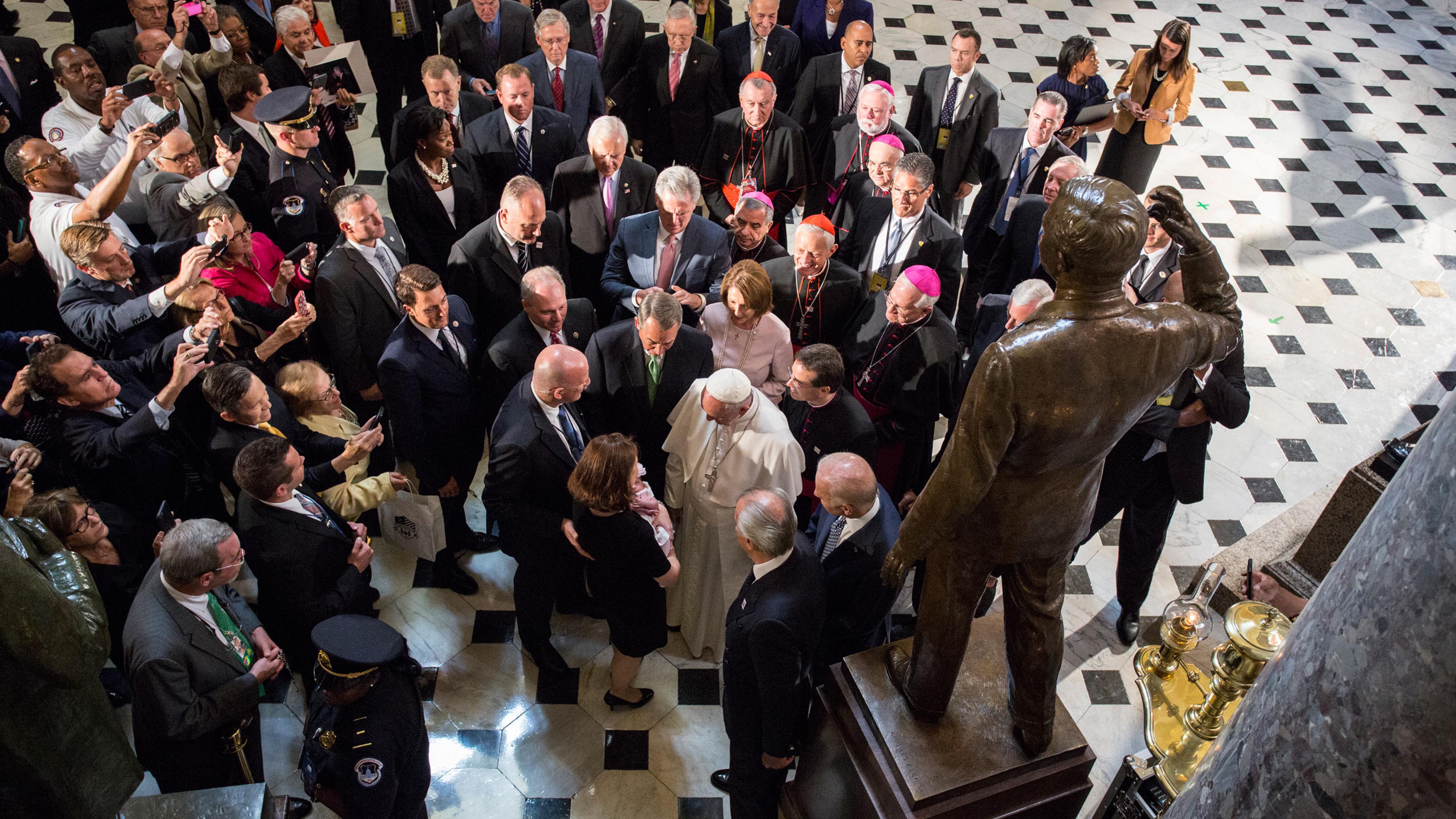 Pope Francis blesses an unidentified child in Statuary Hall at the U.S. Capitol in Washington DC, USA, 24 September 2015. Photograph by Tobias Hutzler for TIME