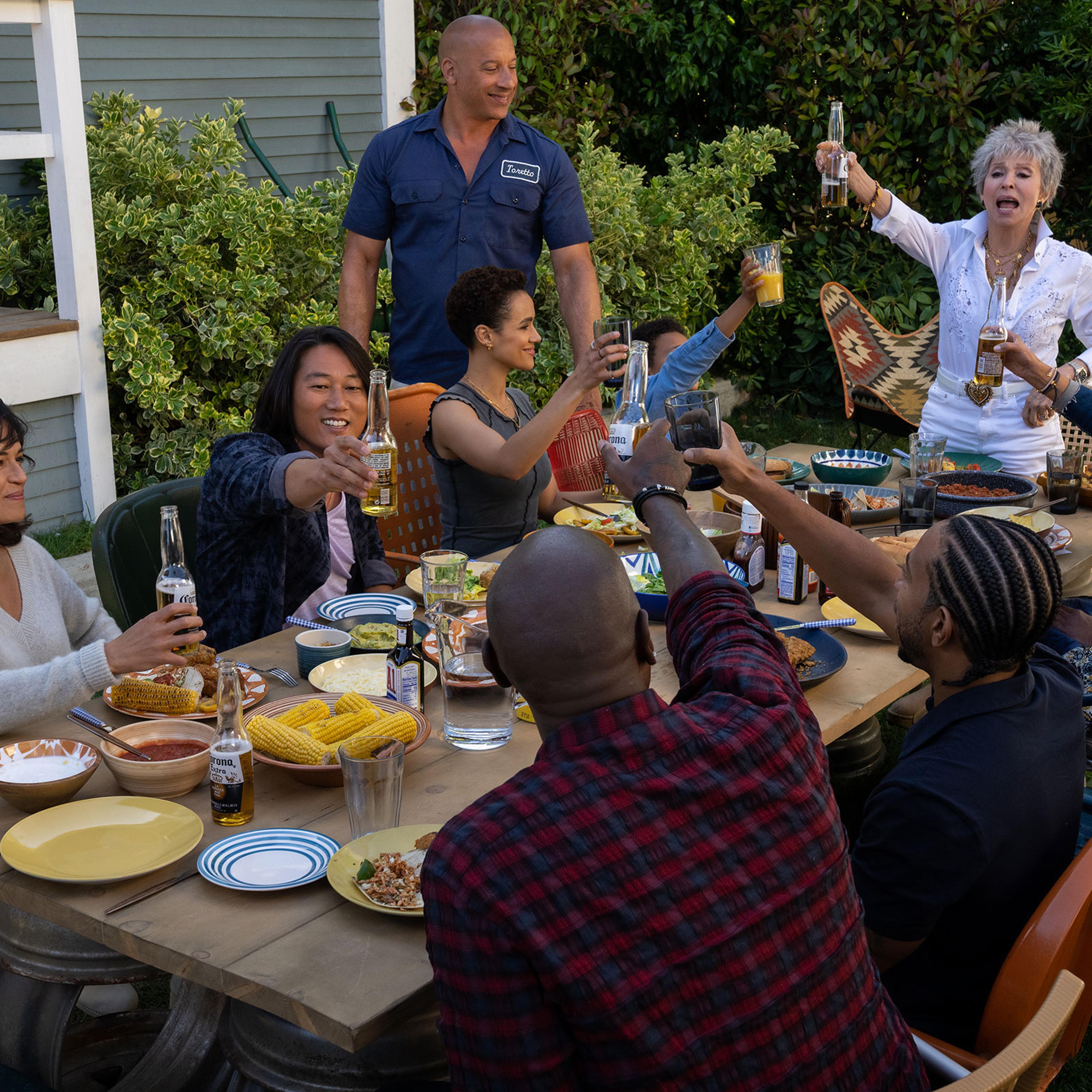 Letty (Michelle Rodriguez), Han (Sung Kang), Ramsey (Nathalie Emmanuel), Dom (Vin Diesel), Little Brian (Leo Abelo Perry), Abuelita (Rita Moreno), Mia (Jordana Brewster), Tej (Chris ‘Ludacris’ Bridges, back to camera) and Roman (Tyrese Gibson, back to ca