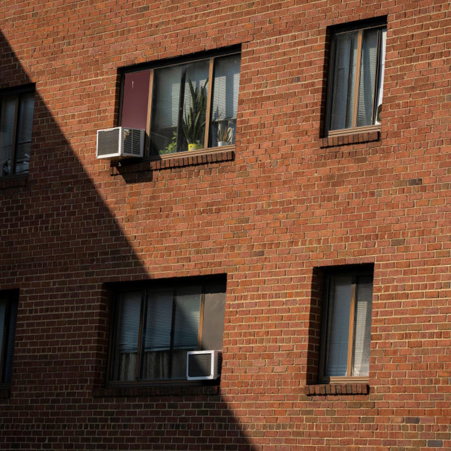 Air conditioning units installed in windows at an apartment complex in Hyattsville, Maryland, on June 17, 2024.