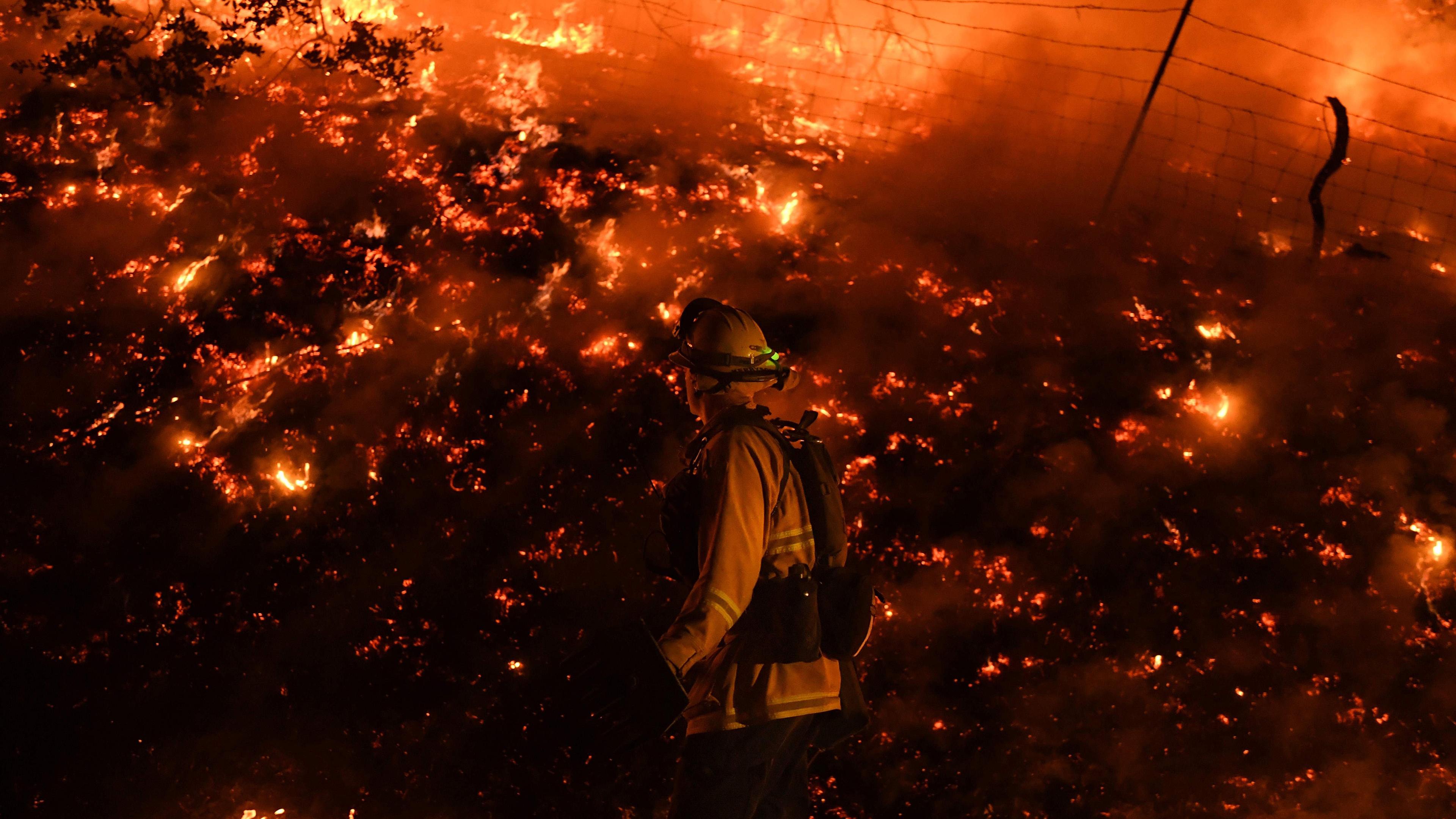 Firefighters conduct a controlled burn to defend houses against flames from the Ranch fire, as it continues to spreads towards the town of Upper Lake, Calif. on Aug. 2.